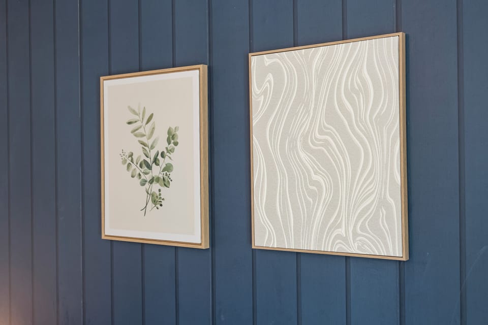 Elegant blue paneled wall with curated art accents