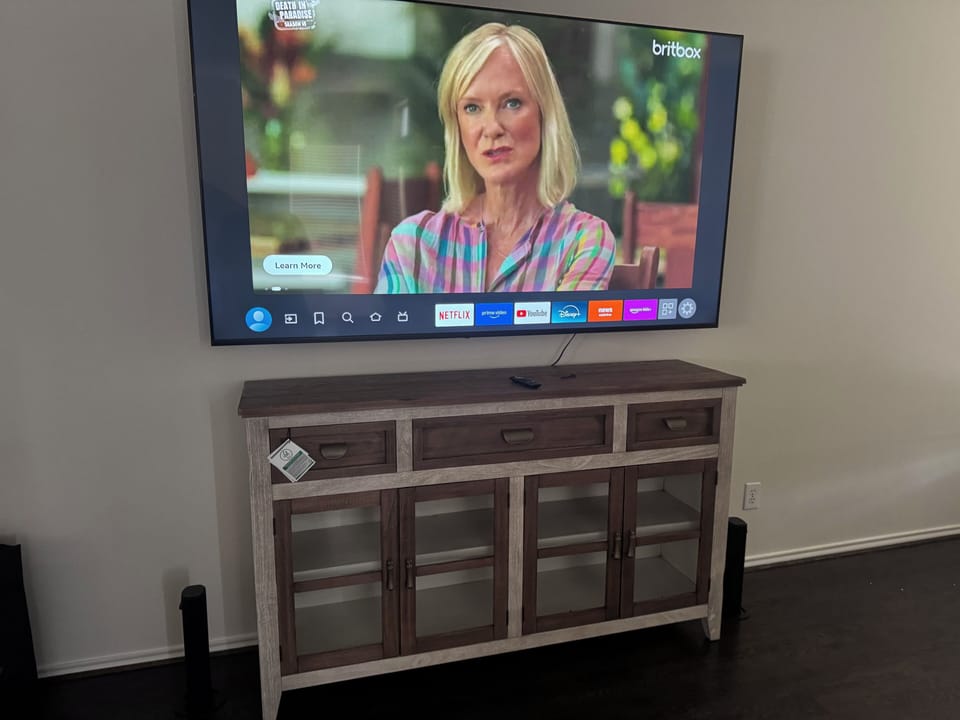 Large smart TV with stylish media console for easy in-home entertainment