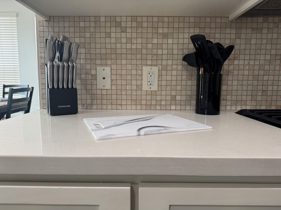 Clean modern kitchen with stocked prep space and essential cooking tools
