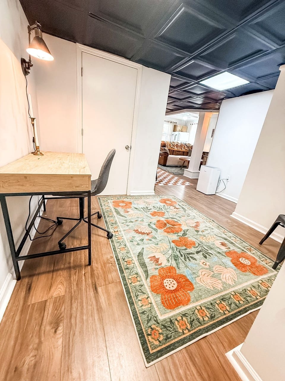 Cozy work nook with bold ceiling, floral rug, and warm modern style