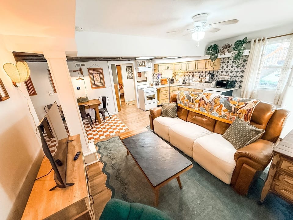 Cozy open living space with bright kitchen, dining nook, and lots of charm