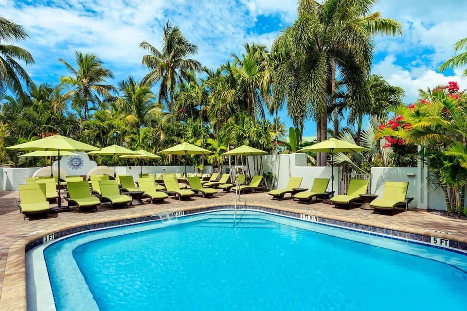 Soak up sunshine poolside with sweeping sea views beyond.
