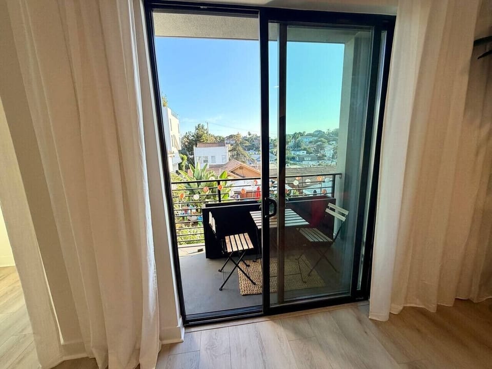A private balcony holds a bistro table for two, perfect for morning coffee or a quiet evening.
