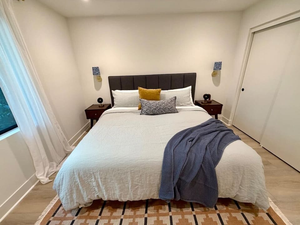 Warm wood nightstands and soft bedding round out this comfortable king bedroom.