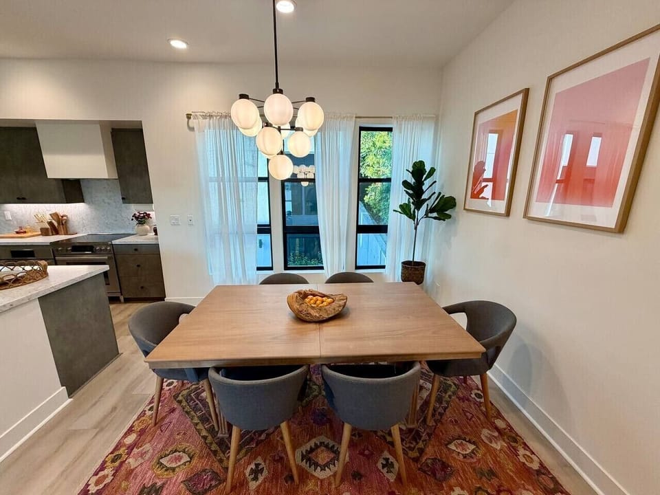 Seating for six beneath a statement chandelier, just off the kitchen for effortless entertaining.