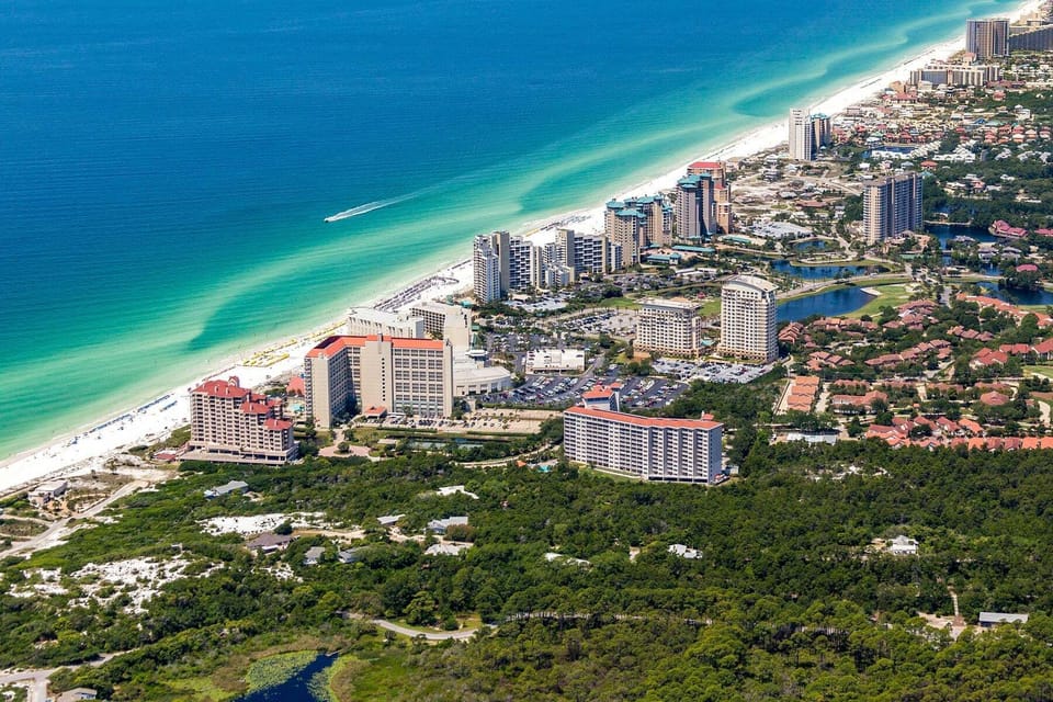 Aerial view of Beach Manor at Tops'l Beach & Racquet Resort in Miramar Beach, Florida, showcasing its beachfront location, sugar-white sand, and emerald-green Gulf of Mexico waters.