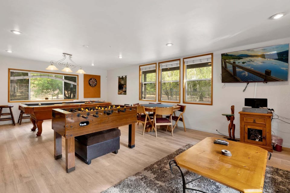 A game room with pool table, foosball, darts and poker game table are perfect for family fun, friendly competition, and unforgettable entertainment during your stay.