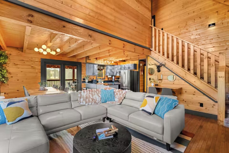 Designed for connection, this spacious living area offers plenty of seating, a cozy fireplace, and room for everyone to gather comfortably after a day of adventure.
