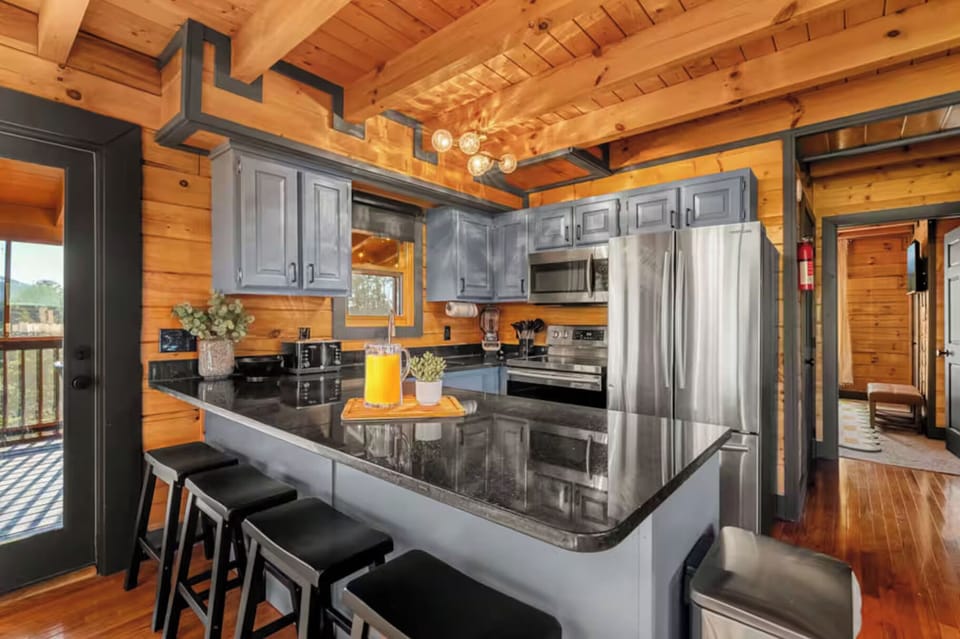 Fully stocked kitchen with stainless steel appliances, generous prep space, and bar seating. Perfect for family meals, group gatherings, and extended stays.