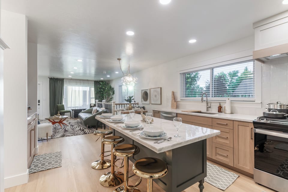 Bright open kitchen with stylish island seating and inviting lounge area