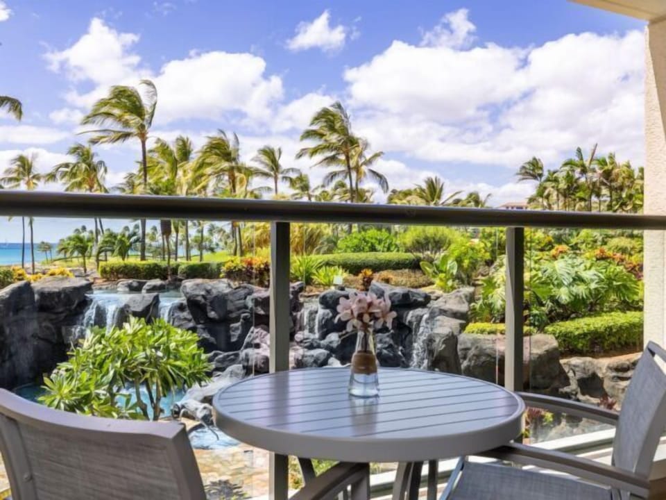 Private tropical lanai with waterfall views and a peek of the ocean