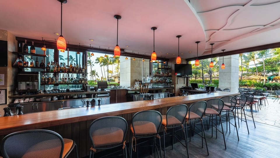 Open-air resort bar with tropical views and elegant lounge seating