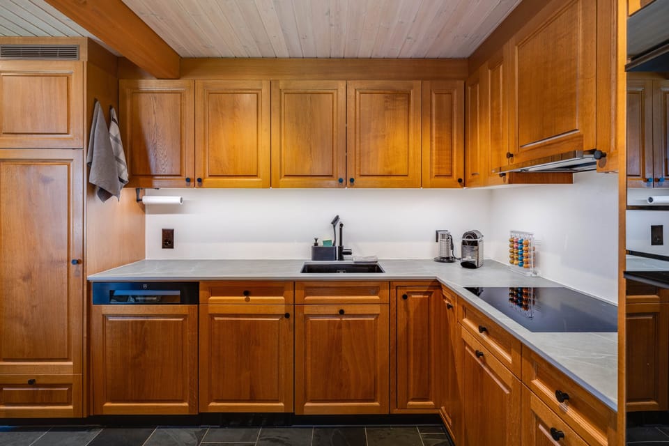 Modern kitchen with high-end appliances incl. steamer, microwave, induction stove, dishwasher