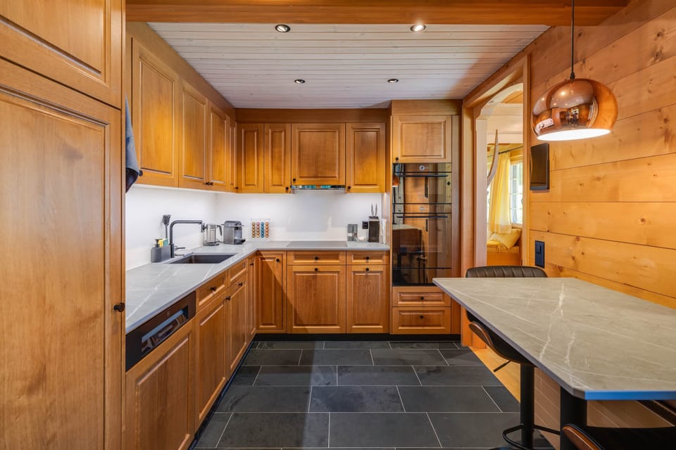 Modern kitchen with high-end appliances incl. steamer, microwave, induction stove, dishwasher