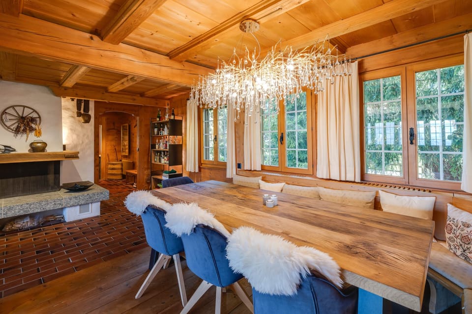 Large dining room with a cozy fireplace and massive oak table, seating 10 people.