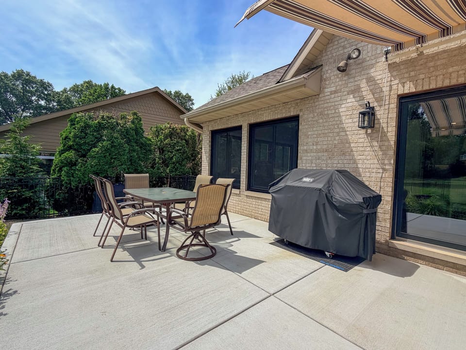Enjoy outdoor dining on the patio with a grill and seating.