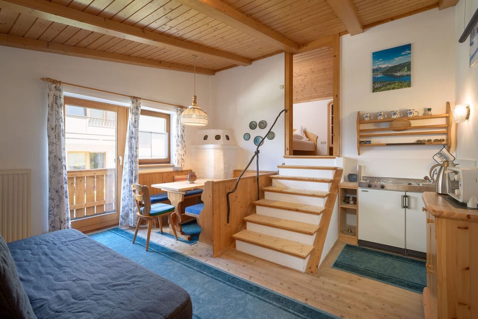Hochfilzen vacation rental with separate apartment-style area, kitchenette, couch, dining table, bedroom and private bathroom.