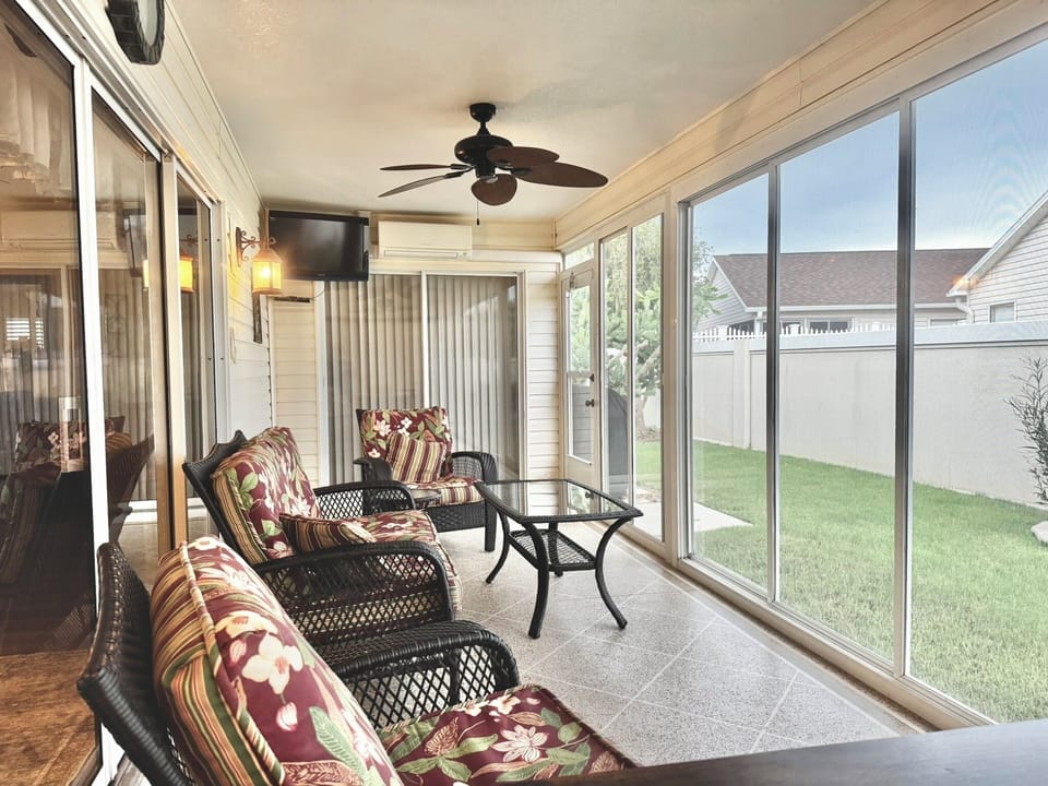 Climate-Controlled Enclosed Lanai w/ Flatscreen TV & Comfortable Lounge Seating. Entrance Points from the Living Room & the Master Bedroom