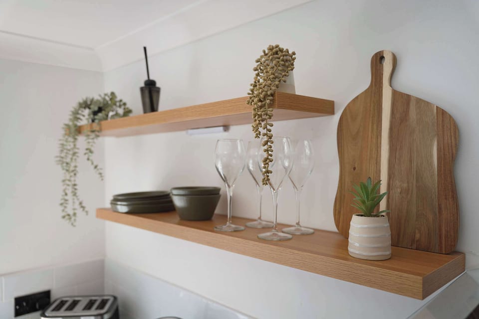The fully equipped kitchen includes an oven, hob, microwave, fridge/freezer, washing machine, breakfast table, and essential cookware, providing everything you need to prepare meals throughout your stay.