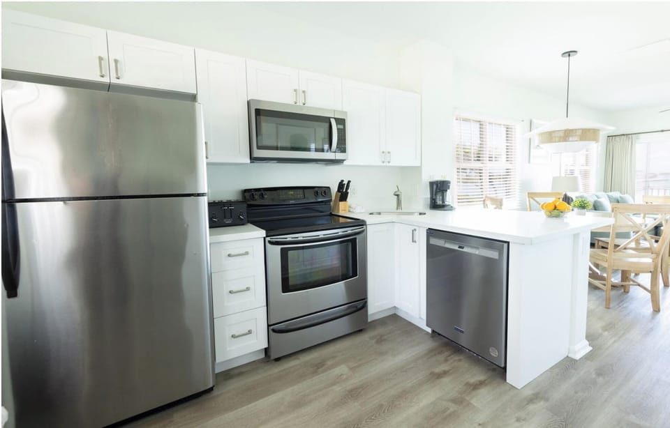 Cook easy meals in a crisp kitchen with stainless appliances.