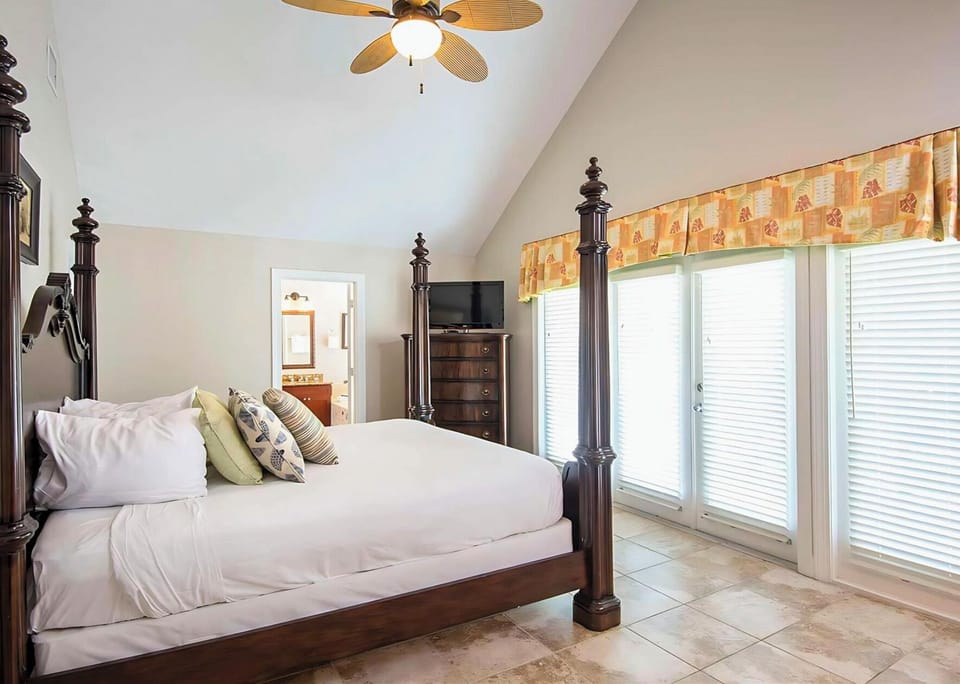 Unwind in a serene king suite with soft coastal light.