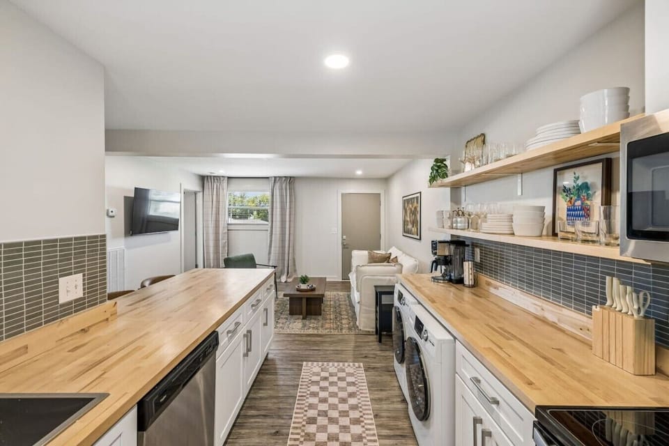 Open floor plan from the kitchen to living room. The kichen is equipped with all the essentials you would need, along with seating at the island high top.