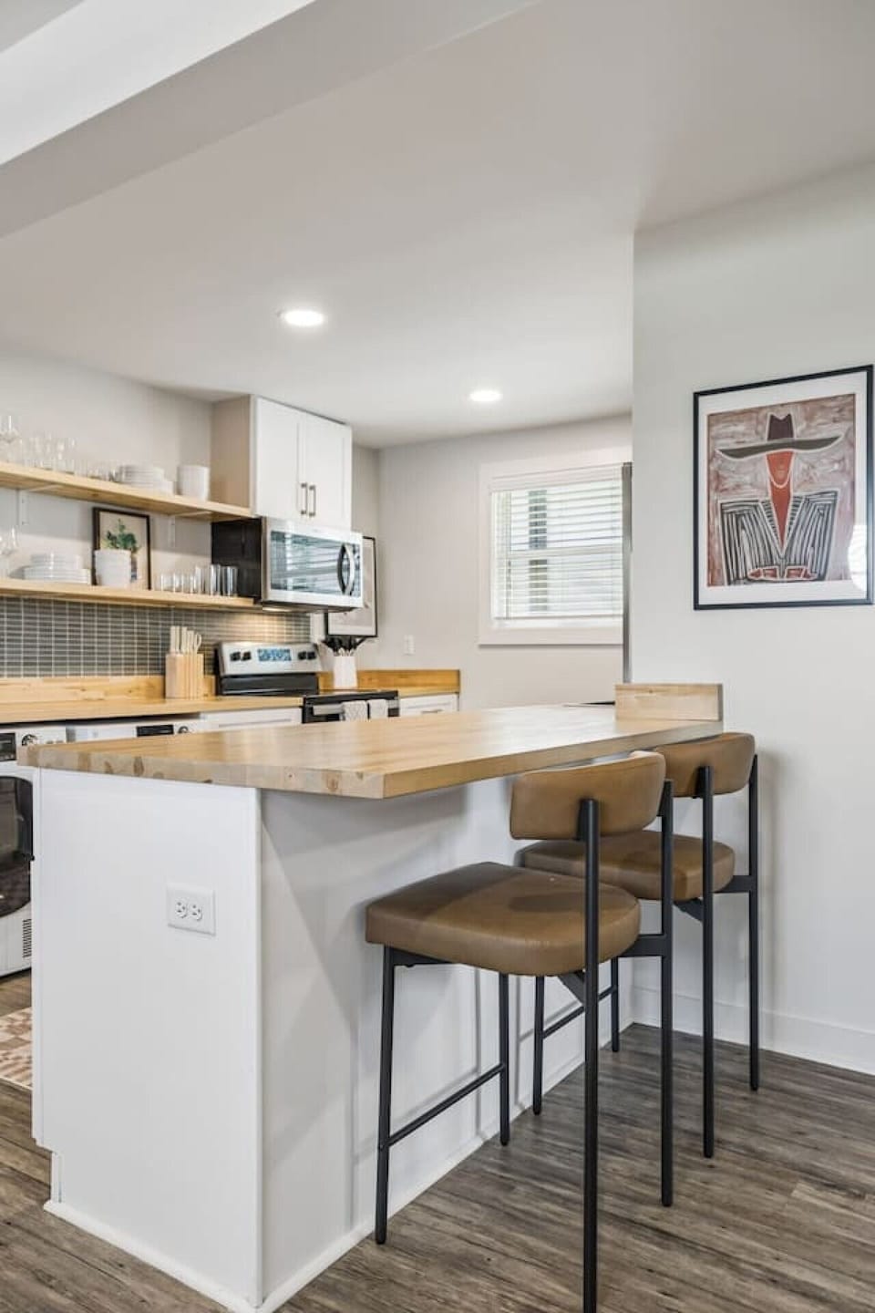 Open floor plan from the kitchen to living room. The kichen is equipped with all the essentials you would need, along with seating at the island high top.
