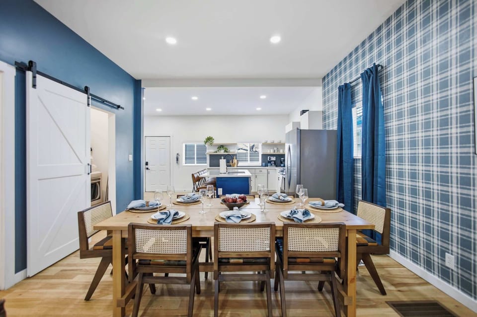 Long farmhouse table seating means the whole group dines together, with the open kitchen just steps away.