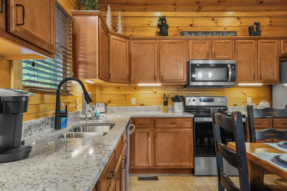 Cozy cabin kitchen with granite counters and warm wood finishes