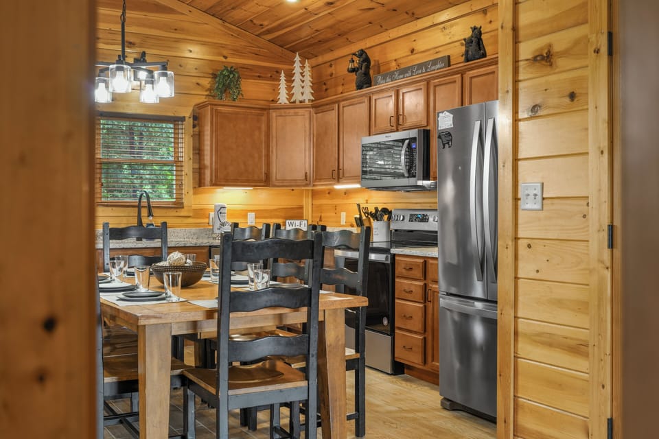 Cozy cabin kitchen with dining space and modern stainless appliances