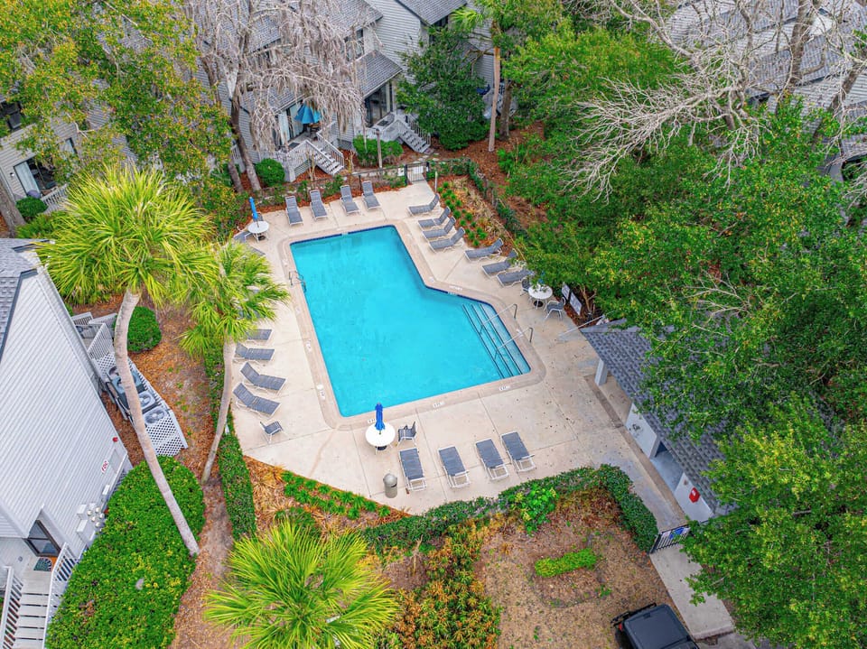 Dive into paradise at 35 Ocean Breeze — your private retreat nestled among Hilton Head's lush canopy. Sun-drenched loungers await beside shimmering turquoise waters. Coastal luxury, reimagined.