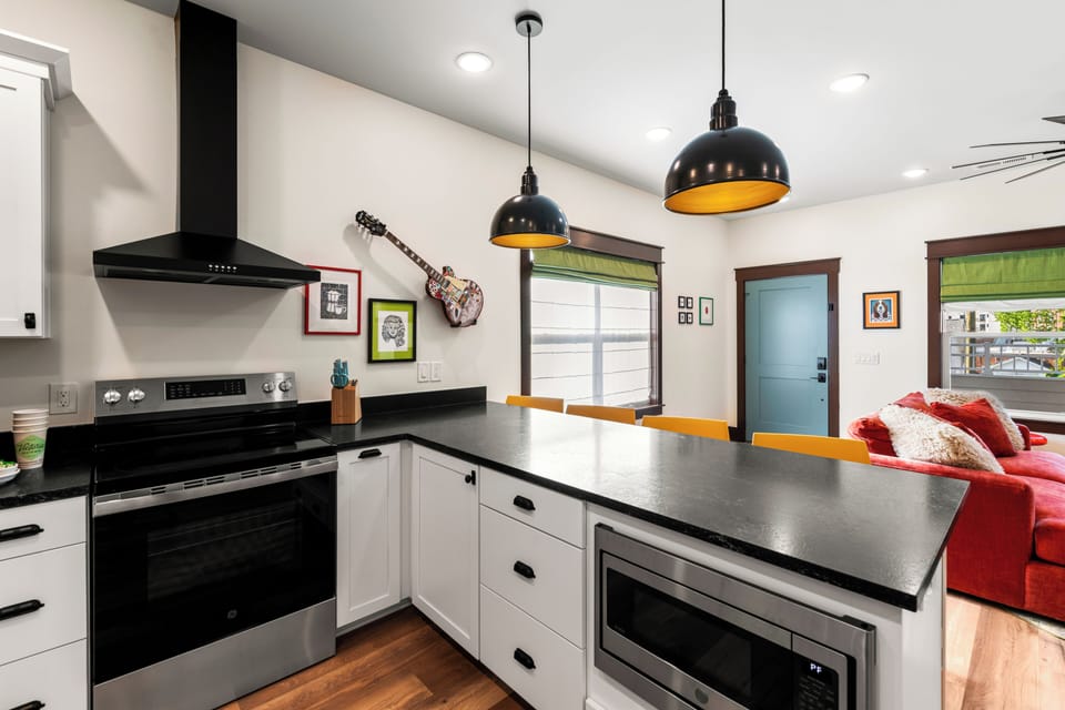 Modern open kitchen with large island, pendant lighting, and stylish finishes