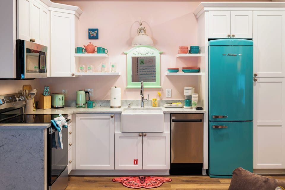 Retro-chic kitchen with farmhouse sink and eye-catching turquoise fridge