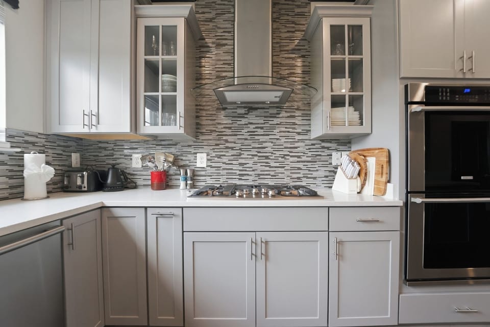 Modern gourmet kitchen with gas cooktop and stylish tile backsplash
