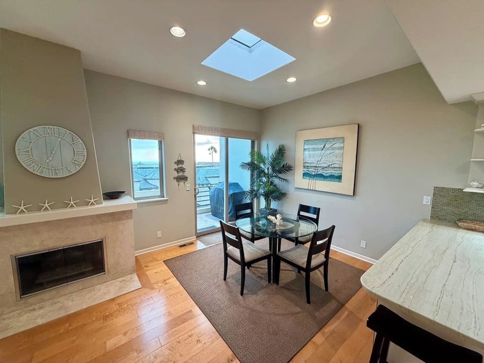 A dining table for four sits just off the kitchen, part of the open living, dining, and kitchen layout on the main level.