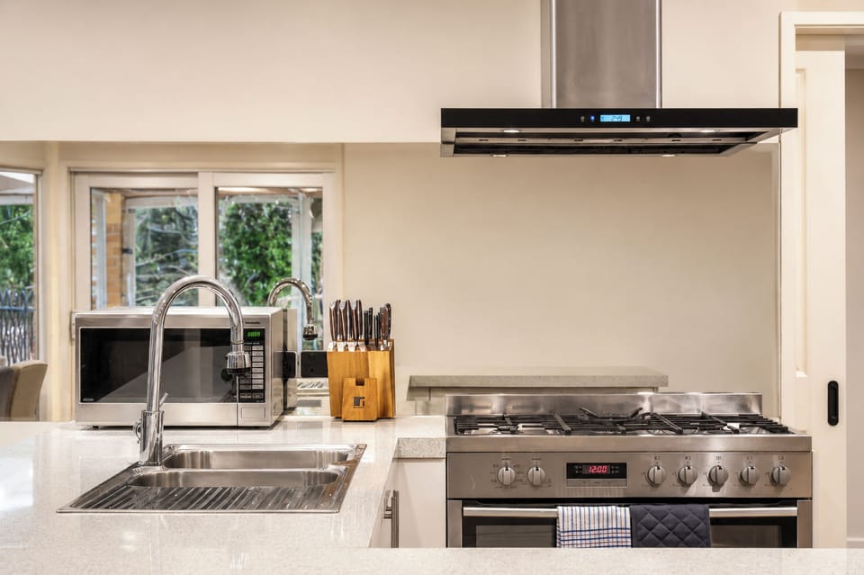 Bright modern kitchen with gas range, double sink, and sleek finishes