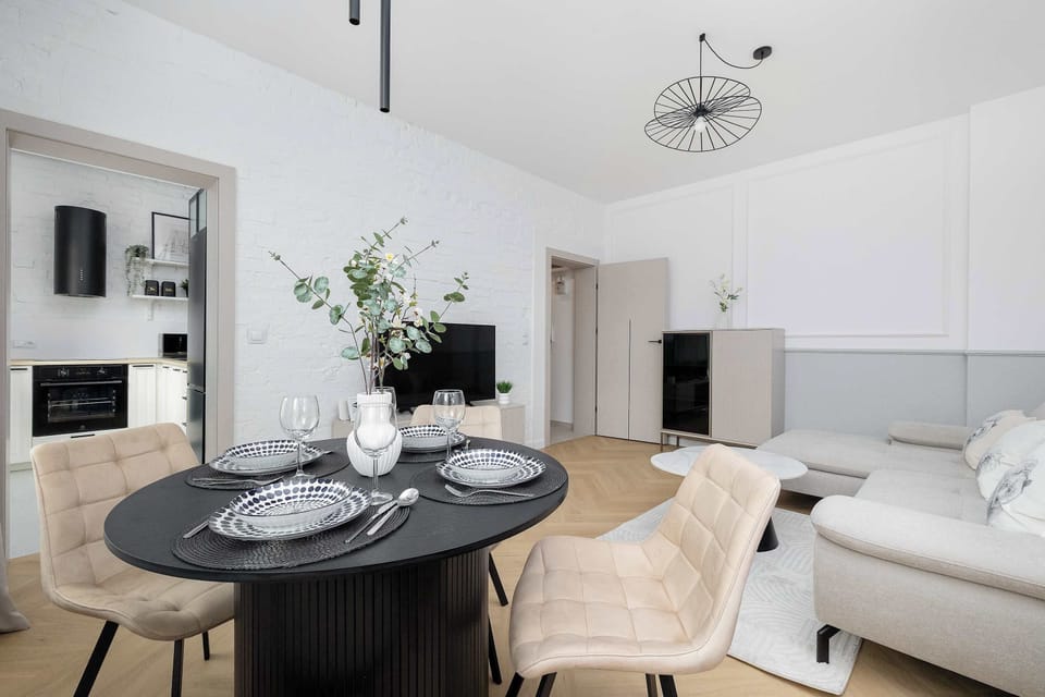 A cozy dining corner with a round table and comfortable chairs next to the living area.