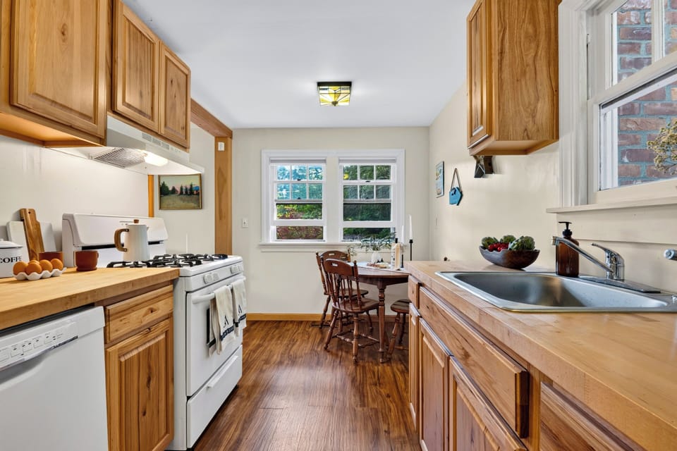 Bright kitchen with warm wood cabinetry, full appliances, and a cozy breakfast nook.