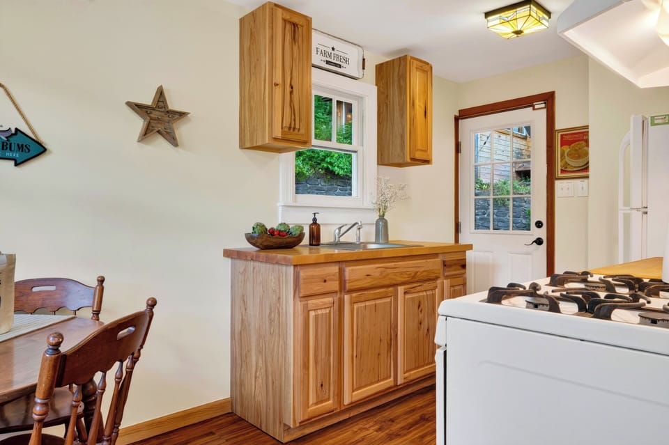 Bright kitchen with warm wood cabinetry, full appliances, and a cozy breakfast nook.