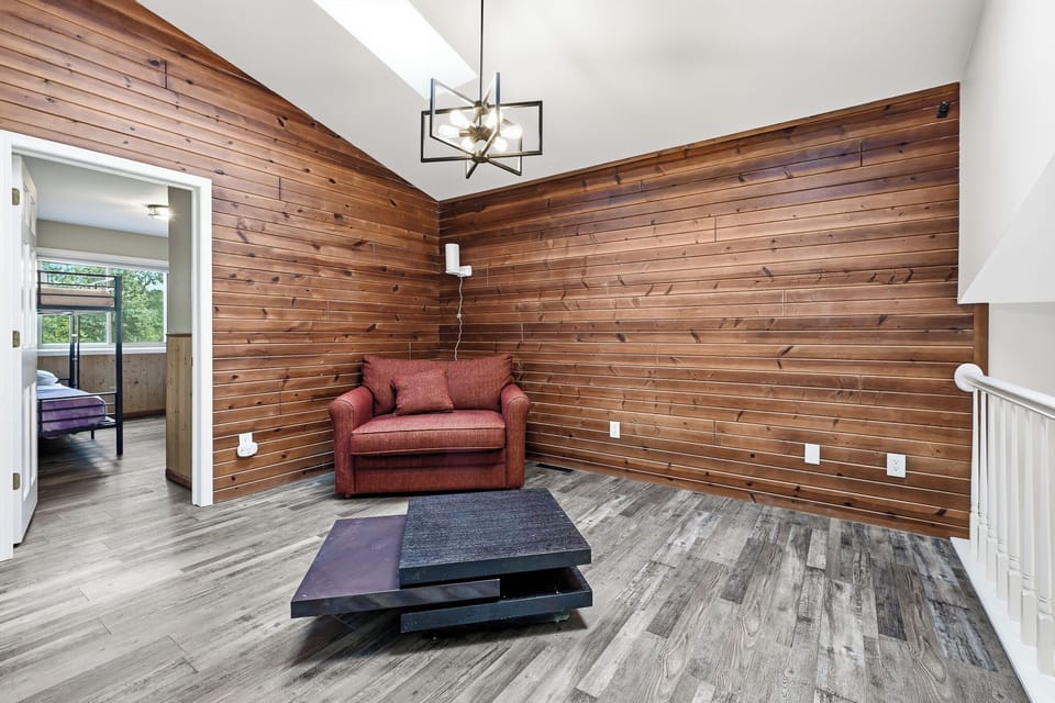 Warm and inviting sitting area with rich wood walls and comfortable seating.