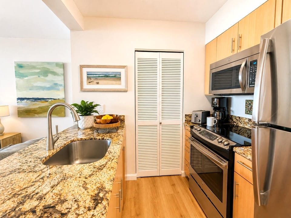 The well appointed kitchen features granite countertops stainless steel appliances and everything needed for your stay
