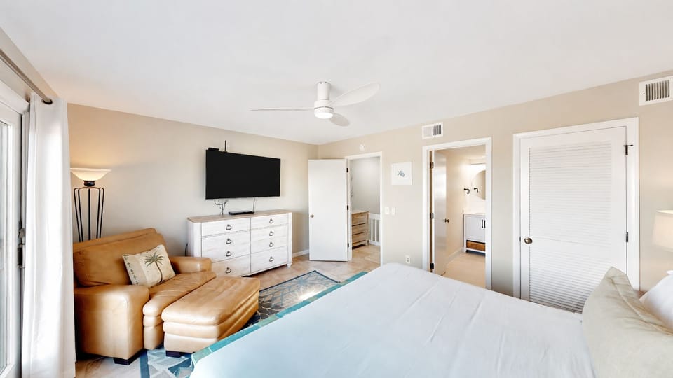 Your bright suite blends comfort and convenience with a cozy leather armchair, soft bedding, en-suite access, and everything you need to relax and recharge after exploring.