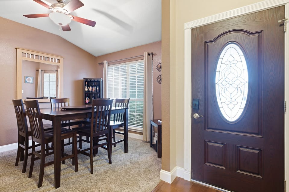 Bright dining area for 6 with natural light and stylish entryway charm