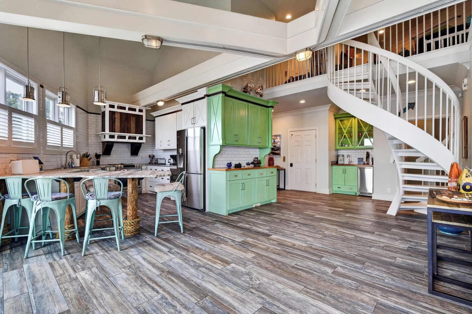 Dining Area: Cook, dine, and gather in this inviting kitchen and dining area, featuring a practical layout, essential appliances, and a cozy coastal atmosphere.