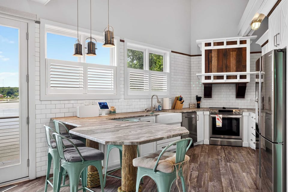 Dining Area: Cook, dine, and gather in this inviting kitchen and dining area, featuring a practical layout, essential appliances, and a cozy coastal atmosphere.