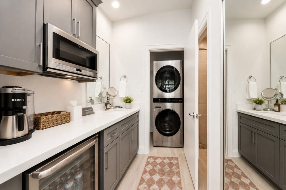 Enjoy home-like convenience with a coffee station, mini fridge, laundry area, and stylish kitchenette all in one space
