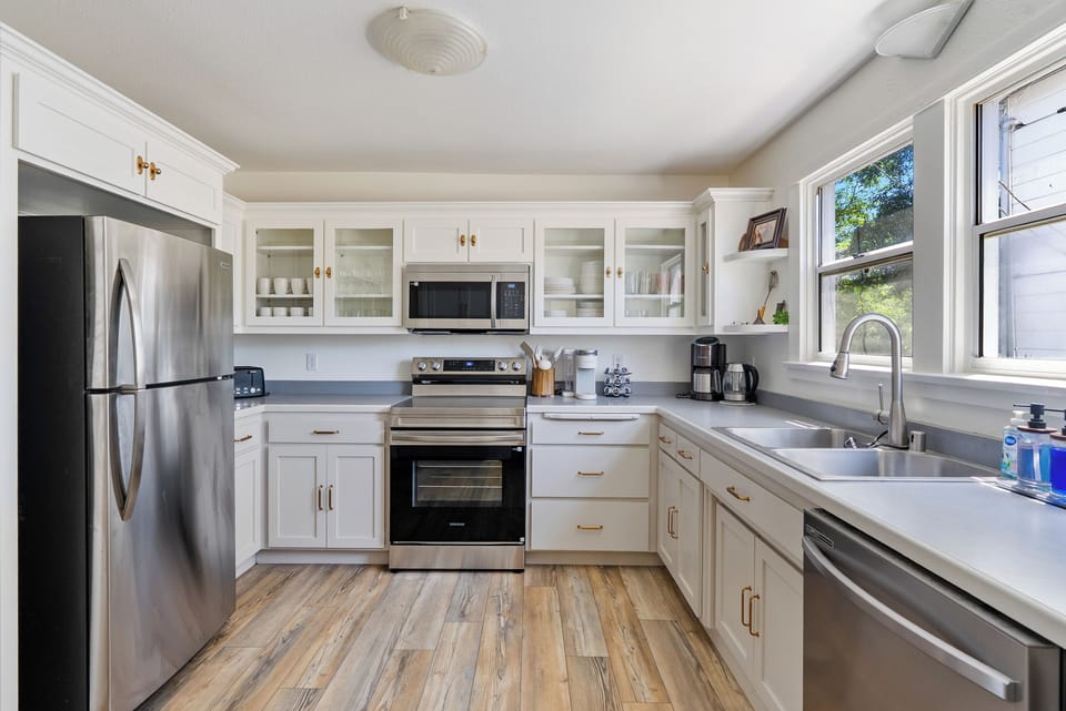 Bright modern kitchen with stainless appliances and sunny workspace