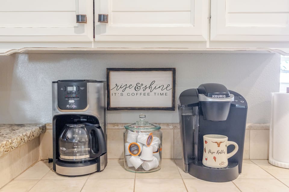 Cozy kitchen coffee station with drip maker, Keurig, mugs, and pods