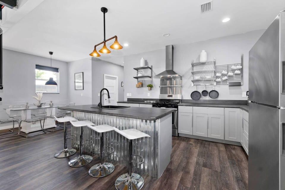 Modern chef’s kitchen with island seating and stylish industrial touches