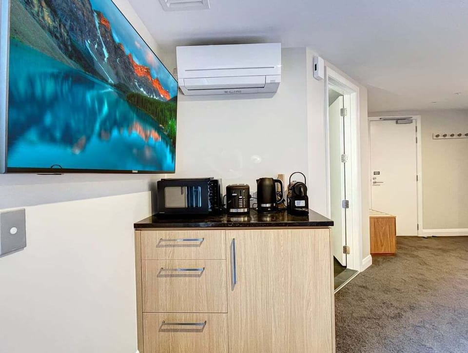 Convenient kitchenette with a coffee machine, microwave, and everything you need for a comfortable stay.